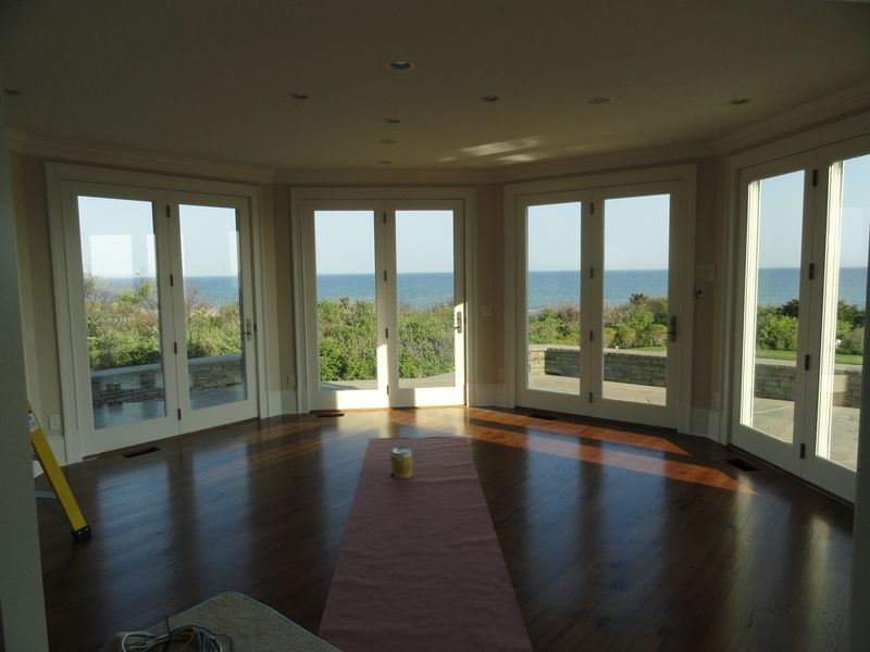 Four sets of French doors opening to patio with ocean view