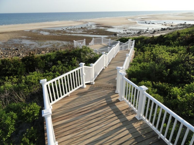 Long wooden stairway to beach with multiple landings