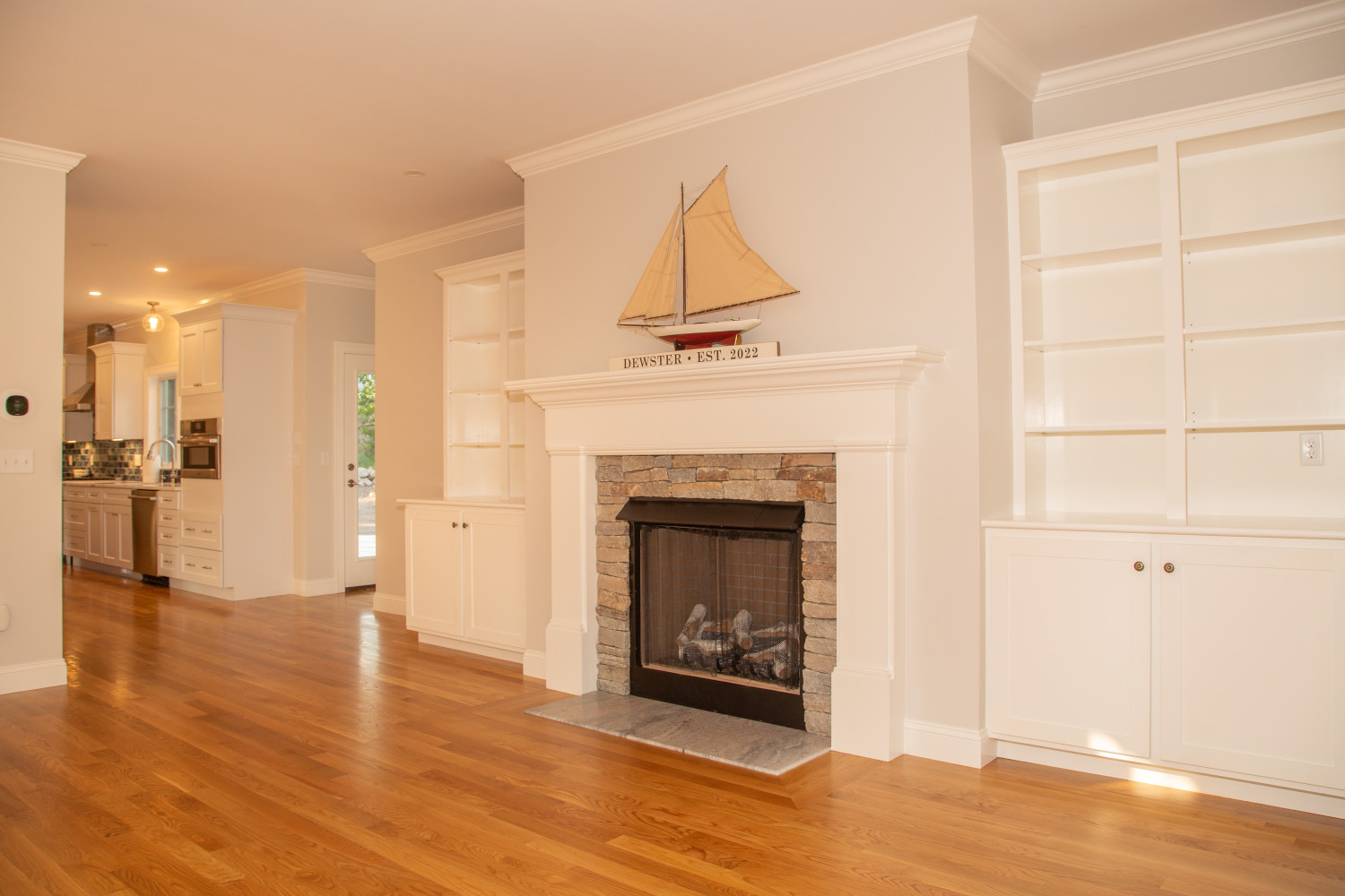 Fireplace., living room, kitchen all wood flooring, open floor plan